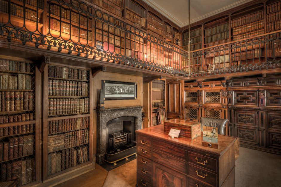 A historic library in Scotland featuring extensive wooden bookshelves filled with books.